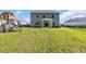 Spacious backyard with play set, patio seating, and ample grass area at 1748 Promise Pl., Myrtle Beach, SC 29588
