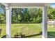 Lush green backyard view with a forested backdrop, visible from the covered patio at 1748 Promise Pl., Myrtle Beach, SC 29588