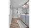 Bathroom featuring a glass enclosed shower and double sink vanity with laminate floors at 1748 Promise Pl., Myrtle Beach, SC 29588