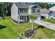 Aerial view of home with well manicured lawn, landscaping, and two-car garage at 1748 Promise Pl., Myrtle Beach, SC 29588