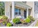 Charming front porch featuring a cozy swing and well-maintained landscaping at 1748 Promise Pl., Myrtle Beach, SC 29588