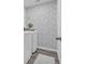 Well-appointed laundry area featuring stylish wallpaper, modern washer and dryer and grey wood-look floors at 1748 Promise Pl., Myrtle Beach, SC 29588
