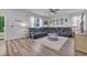 An elegant living room features wood floors, a ceiling fan, and a modern sofa at 1748 Promise Pl., Myrtle Beach, SC 29588