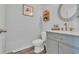 Stylish powder room with wood-look floors, elegant mirror, and charming vanity at 1748 Promise Pl., Myrtle Beach, SC 29588