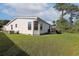 Spacious backyard with lush green grass, a modern grill and a view of the white home exterior at 1755 Fairbanks Dr., Conway, SC 29526