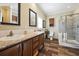 Bathroom with double vanity, tile floors, framed mirrors, and a glass-enclosed shower at 1755 Fairbanks Dr., Conway, SC 29526