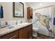 Bathroom featuring wood cabinets, marble countertops, and decorative turtle shower curtain and mirror at 1755 Fairbanks Dr., Conway, SC 29526