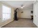 A carpeted bedroom with a ceiling fan and neutral colors, suitable for exercise equipment and home office setup at 1755 Fairbanks Dr., Conway, SC 29526