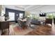 Open-concept living space with hardwood floors, a dining area, and a comfortable living room with a TV at 1755 Fairbanks Dr., Conway, SC 29526