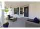 Cozy front porch featuring comfortable seating, decorative plants, and a welcoming entrance with a glass paneled door at 1755 Fairbanks Dr., Conway, SC 29526