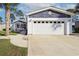 A white garage door is attached to the house with well-maintained landscaping and a walkway to the front door at 1755 Fairbanks Dr., Conway, SC 29526