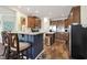 Modern kitchen features an island with seating and stainless steel appliances and tile floors at 1755 Fairbanks Dr., Conway, SC 29526