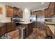 Kitchen with wooden cabinets, stainless steel appliances, and a central island with seating at 1755 Fairbanks Dr., Conway, SC 29526
