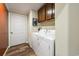 Efficient laundry room with modern washer and dryer units, storage cabinets, and sleek flooring at 1755 Fairbanks Dr., Conway, SC 29526