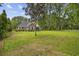 Beautifully landscaped backyard with lush lawn and mature trees, providing a private and serene setting at 180 Waterhall Dr., Murrells Inlet, SC 29576
