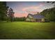 Expansive backyard featuring a well-maintained lawn and a view of the home's exterior at 180 Waterhall Dr., Murrells Inlet, SC 29576