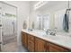 Bright bathroom with double vanity, large mirror, and shower with glass door at 180 Waterhall Dr., Murrells Inlet, SC 29576