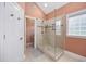 Elegant bathroom boasts a frameless shower and neutral finishes for a spa-like retreat at 180 Waterhall Dr., Murrells Inlet, SC 29576