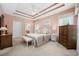 Comfortable bedroom with tray ceilings, ceiling fan, dresser, and inviting decor at 180 Waterhall Dr., Murrells Inlet, SC 29576