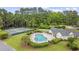Aerial view of a luxurious community pool, clubhouse, playground, and tennis courts at 180 Waterhall Dr., Murrells Inlet, SC 29576