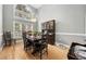 Dining room with a large window, wood floors, chandelier, and wooden china cabinet at 180 Waterhall Dr., Murrells Inlet, SC 29576