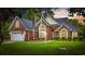 Beautiful brick home with a well-manicured lawn and mature landscaping creates fantastic curb appeal at 180 Waterhall Dr., Murrells Inlet, SC 29576