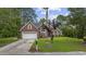 Charming brick home with mature trees, manicured lawn, and a welcoming two-car garage at 180 Waterhall Dr., Murrells Inlet, SC 29576