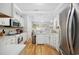 Bright and airy kitchen features white cabinets, stainless steel appliances, and a convenient breakfast bar at 180 Waterhall Dr., Murrells Inlet, SC 29576
