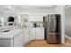 Spacious kitchen boasts a stainless steel refrigerator, ample counter space, and views into the living room at 180 Waterhall Dr., Murrells Inlet, SC 29576