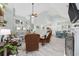 Open-concept living room with fireplace, high ceilings, and view to the dining room and kitchen at 180 Waterhall Dr., Murrells Inlet, SC 29576