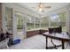 Bright sunroom with tiled floors, large windows, and peaceful backyard views at 180 Waterhall Dr., Murrells Inlet, SC 29576