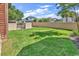 The backyard showcases a lush green lawn, bordered by a sturdy fence for privacy and security at 194 Avenue Of The Palms, Myrtle Beach, SC 29579