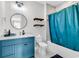Bathroom boasts a blue vanity, complemented by modern fixtures and practical shelving for toiletries at 194 Avenue Of The Palms, Myrtle Beach, SC 29579