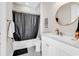 Cozy bathroom featuring a shower with black curtain, white vanity with marble countertop, and tiled floor at 194 Avenue Of The Palms, Myrtle Beach, SC 29579