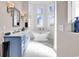 Stylish bathroom with double vanity, soaking tub beneath a bay window, and modern fixtures at 194 Avenue Of The Palms, Myrtle Beach, SC 29579
