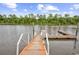 A wooden dock extends into the calm water, inviting relaxation and waterfront enjoyment at 194 Avenue Of The Palms, Myrtle Beach, SC 29579