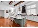 Modern kitchen with an island, stainless appliances, and staircase access at 194 Avenue Of The Palms, Myrtle Beach, SC 29579
