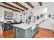 Open kitchen with a large island, stainless appliances, hardwood floors, and a living area at 194 Avenue Of The Palms, Myrtle Beach, SC 29579