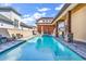Backyard pool area features a shimmering pool with a spa and stone-clad columns at 194 Avenue Of The Palms, Myrtle Beach, SC 29579