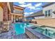 The backyard has a luxurious swimming pool and spa, all bordered by beautiful stone landscaping at 194 Avenue Of The Palms, Myrtle Beach, SC 29579