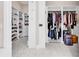 Organized walk-in closet with custom shelving, hanging racks, and marble tile flooring for ample storage at 194 Avenue Of The Palms, Myrtle Beach, SC 29579