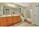 Well-lit bathroom with a double vanity, framed mirror, and shower-tub combo with curtains at 199 Gilman Rd., Pawleys Island, SC 29585