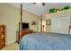 Bedroom showcasing a draped bed, wood dresser with a TV and a John Deere tractor at 199 Gilman Rd., Pawleys Island, SC 29585