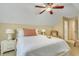 Bright bedroom with a white quilted bed, bedside tables and lamps, and a ceiling fan at 199 Gilman Rd., Pawleys Island, SC 29585