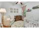 Bedroom with beautiful decor, including a crib, and an accent chair, and hardwood floors at 199 Gilman Rd., Pawleys Island, SC 29585
