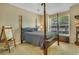 Cozy bedroom featuring a four-poster bed, natural light and learning easel at 199 Gilman Rd., Pawleys Island, SC 29585
