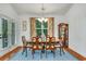 Elegant dining room with a chandelier, floral curtains, and access to the patio at 199 Gilman Rd., Pawleys Island, SC 29585