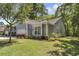 Charming home featuring mature landscaping, an American flag, and a well-maintained lawn at 199 Gilman Rd., Pawleys Island, SC 29585