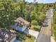 Inviting home nestled among lush trees, featuring an attached garage and long driveway at 199 Gilman Rd., Pawleys Island, SC 29585