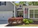 Charming front entrance with an American flag, stylish wreath, and well-manicured landscaping at 199 Gilman Rd., Pawleys Island, SC 29585
